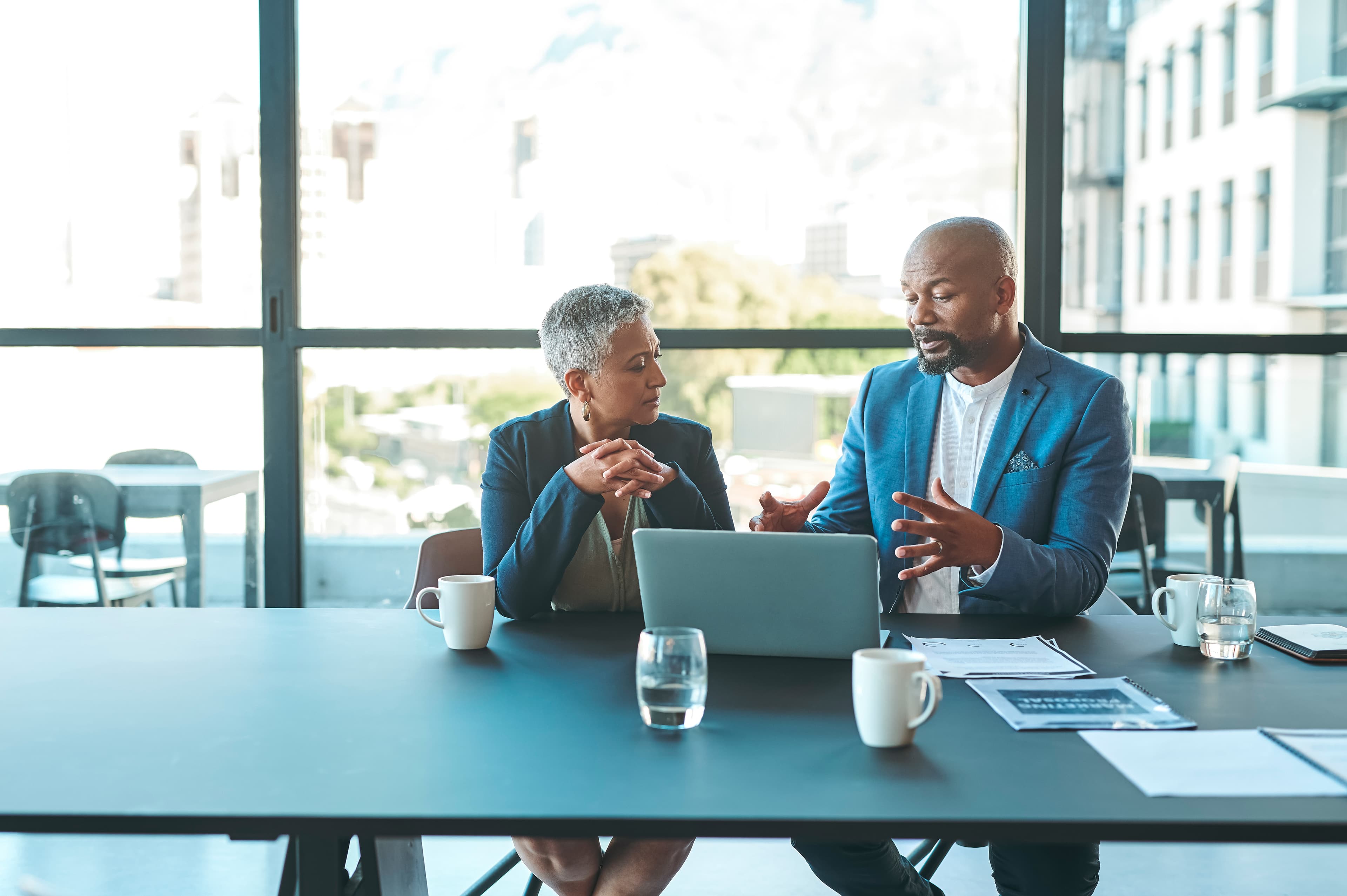 Two senior professionals in strategic discussion